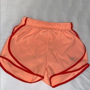 salmon Nike running shorts